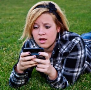 Cariati Law Toronto, Ontario Injury Lawyers Personal Injury School Bullying Cyber Bullying Teenage Girl on Phone