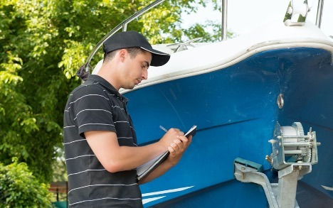 Man performing a full boat inspection in Ontario Canada