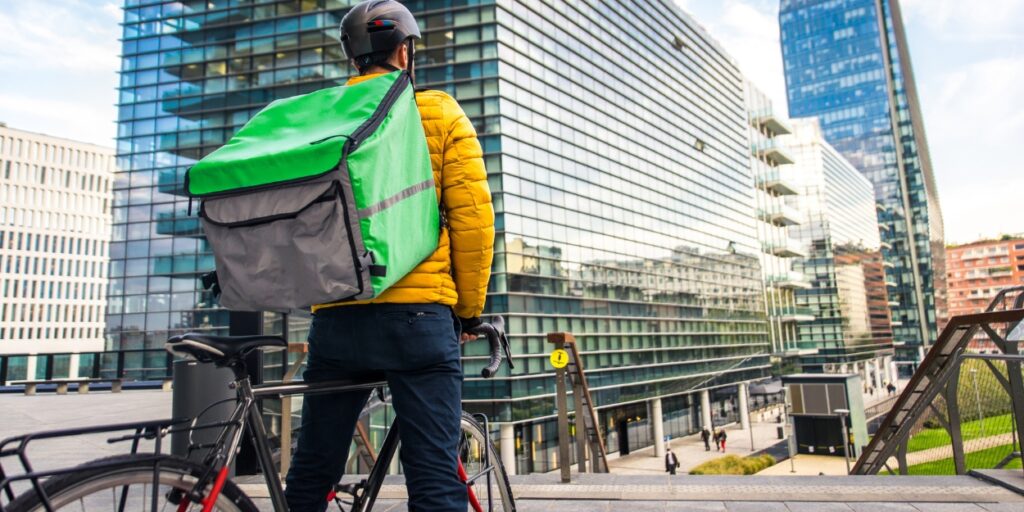 Food delivery guy on bicycle in Toronto right before a bicycle accident